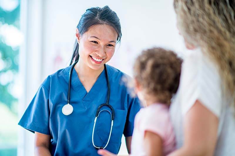 pediatrician smiling at infant