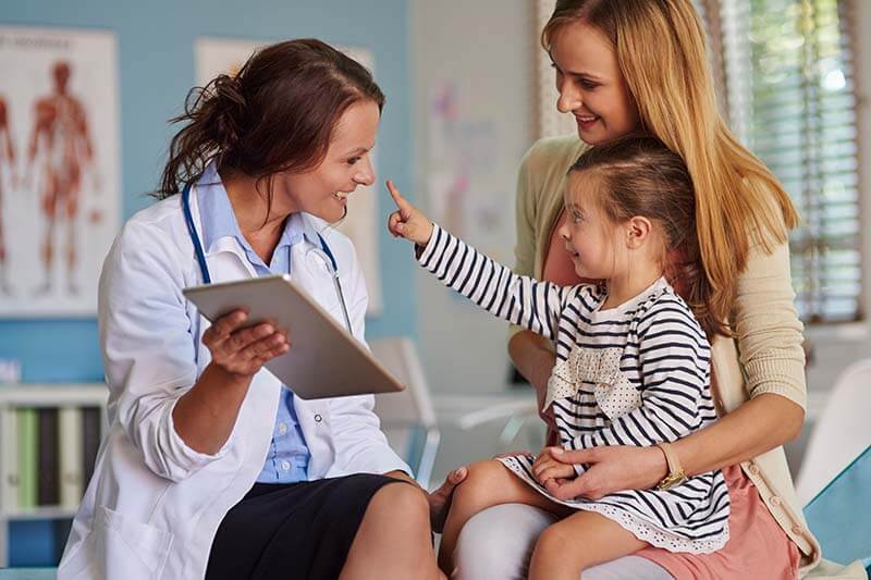 pediatrician talking to little girl